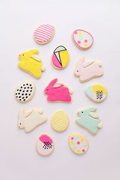 some decorated cookies are laying on a white surface with polka dots and other items in the shape of animals