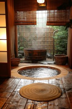 an indoor hot tub in the middle of a room with wooden floors and bamboo shades