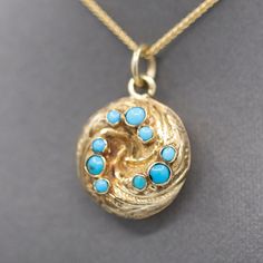 This is an absolutely gorgeous locket that is sure to charm its owner! The locket features a swirl design and is decorated with engraving and nine turquoise beads bezel set into the top. The locket has a glass back which currently holds a plaited lock of hair. If desired that can be removed and a photo or other momento can be placed inside! The locket is crafted in 14k and weighs 3.47g. It measures just shy of 1" in length including the bail, and it is 5/8" across in width. The chain is sold sep Lock Of Hair, Round Locket, Hair Locks, Swirl Design, Plaits, Turquoise Beads, Antique Victorian, Bezel Setting, Locket