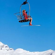 a person on skis is in the air with a chair lift attached to them