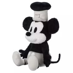 a black and white mickey mouse stuffed animal with a hat on it's head