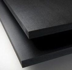 two pieces of black plywood are stacked on top of each other in this close up photo