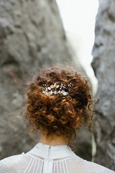 the back of a woman's head wearing a tiara with leaves on it