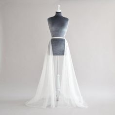 a mannequin with a white veil on it