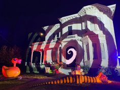 a large house decorated for halloween with fake pumpkins