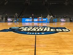 a basketball court with the words march madness on it and people sitting in the bleachers