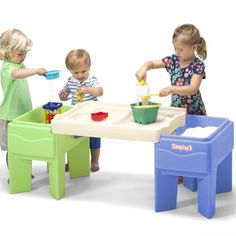 three children playing with toys at a table