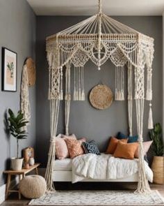 a bedroom with a canopy bed, rugs and pictures on the wall above it