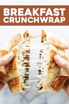 someone holding up a sandwich wrapped in plastic wrap with the words, breakfast crunchwrap