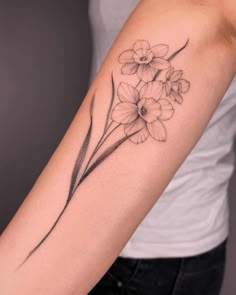 a woman's arm with flowers on it