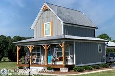 a small gray house with a porch and covered patio