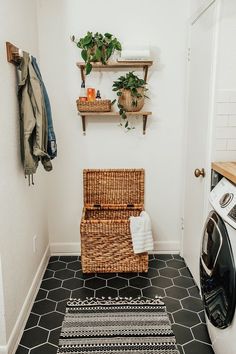 a laundry room with a washer and dryer on the wall next to it