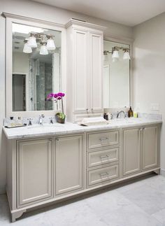 a large bathroom with two sinks and mirrors