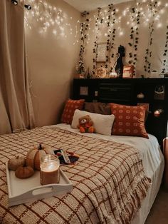 a bedroom with lights strung over the headboard, bed and pillows on top of it