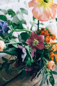 an arrangement of flowers on a wooden table