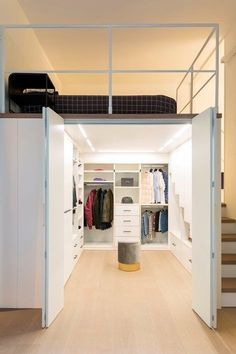 an open closet with stairs leading up to it