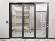 an empty walk in closet with glass doors