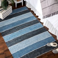 a blue rug on the floor in a bedroom