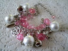 "This beautiful bracelet has pink faceted beads, pink Czech glass beads, pearl beads, pewter silver bead caps, silver foil beads, pewter silver pentacle and pewter silver charms. 7\" long can be adjusted to 8\". Lobster clasp." Handmade Mystical Pink Jewelry, Pink Handmade Mystical Jewelry, Pink Mystical Handmade Jewelry, Handmade Pink Gothic Jewelry, Goddess Magic, Wicca Jewelry, Wiccan Jewelry, Witch Jewelry, Pagan Jewelry