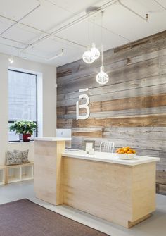 an office with wooden walls and white counters