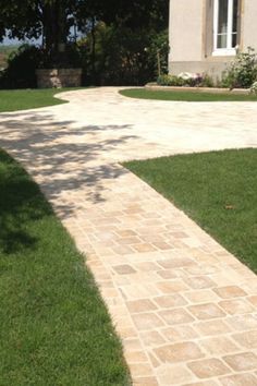 a brick walkway in front of a house