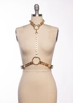 The Spina Harness is a classic harness style with a glam twist. Luxe metallic leather is lined in soft sueded pigskin and stitched. Matching spikes march up the front and around the back. Buckles at the back of neck and sides of waist for an easily adjustable fit. The choker is detachable and can be worn separately. Matching gold or silver toned hardware. Also available in gold glitter or silver glitter PVC. All pieces are MADE TO ORDER, standard sizes XS-4XL. If your measurements fall outside t Leather Strapped Harness, Adjustable Harness For Festival, Punk Style Harness For Night Out, Harness Style, Fall Outside, Chest Harness, Pig Skin, Gold Leather, Metallic Leather