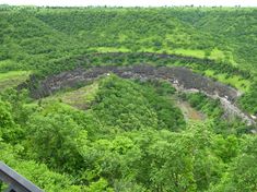 a view from the top of a hill looking down at trees