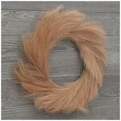 a close up of a furry wreath on a wooden surface