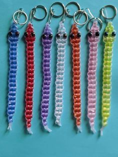 six different colors of beaded keychains on a blue background