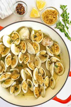 clams and other ingredients in a pan on a table