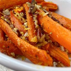 some carrots are sitting in a white bowl