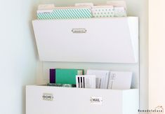 two white bins with file folders and binders on them