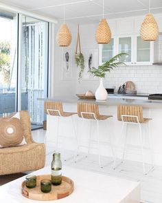 a living room filled with furniture next to a kitchen