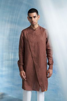 Step into elegance with this meticulously crafted 3-piece ensemble, featuring a statement woody brown linen kurta & jacket designed to turn heads. Adorned with a full-front placket and a mandarin collar, this kurta exudes timeless charm with a contemporary twist. Artfully placed shimmer, underlined with a flap, adds a touch of allure and uniqueness to the design. Paired with comfortable cotton pants and an overlap uniquely cut jacket, this ensemble is perfect for any occasion. Tuxedo Accessories, Beach Wedding Guests, Jacket Cape, Summer Bride, Rohit Bal, Asymmetric Jacket, Summer Wedding Guests, Beach Bride, Sharara Set