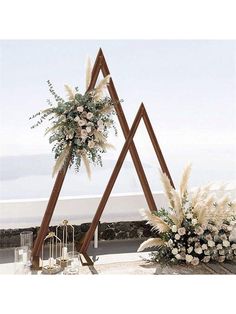 an outdoor ceremony setup with flowers and greenery