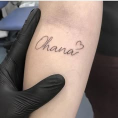 a woman's arm with the word shana written on it in cursive font