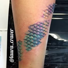 an image of a tattoo on someone's leg that looks like it has fish scales all over it