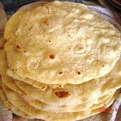 a stack of tortillas sitting on top of a table