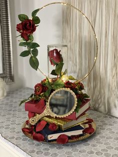 a stack of books sitting on top of a table next to a mirror