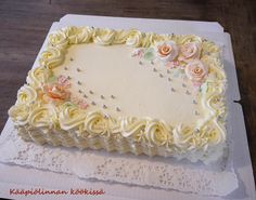 a cake with white frosting and flowers on it