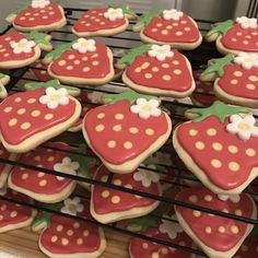 some cookies are decorated like strawberries and flowers