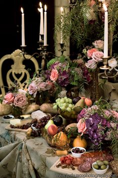 a table topped with lots of different types of fruit and vegetables on top of a cloth covered table