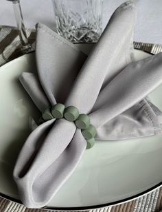 a white plate topped with a gray napkin