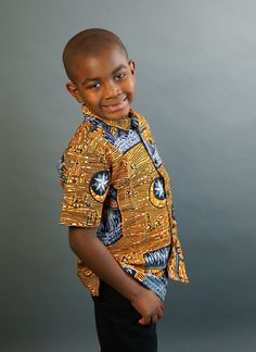 This short sleeved African Print shirt is real cute. Dress him up in this cute African outfit and he will attract a lot of attention and draw tons of compliments. He can wear it whenever he wants to project his African Identity. He can wear it to church, during Sankofa, Kwanzaa, and any African American or Afrocentric Cultural event. *Hand Sewn African Dress *Made by Local Artisans in Africa *100% Cotton *Made in Ghana *Portions of proceeds donated to charities in Africa *Everything in stock is Ankara Shirt, African Shirt, African Print Shirt, Dashiki Shirt, African Shirts, Boy Shirt, Kwanzaa, Local Artisans, African Dress