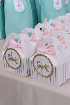 small boxes with pink bows on them sitting on a table