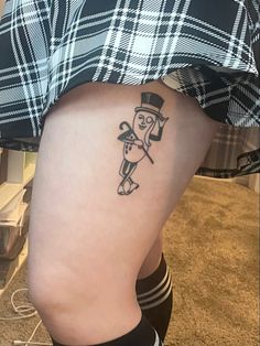 a person with a small tattoo on their lower leg and the bottom half of her thigh