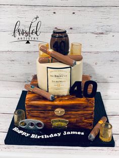 a birthday cake made to look like a trunk with cigars and bottles on it