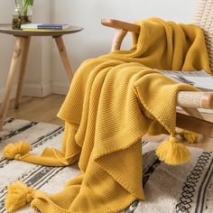 a yellow blanket draped over a wooden chair