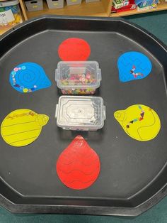 a black tray with different shapes and colors on it in a store display area for children to see