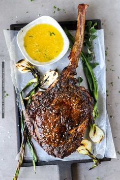 grilled lamb chops with asparagus and mustard sauce on a platter